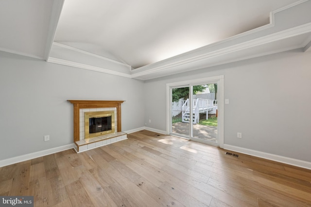 11704 Milbern Dr, Potomac, MD 20854 - unfurnished living room featuring vaulted ceiling, hardwood / wood-style flooring, and a tile fireplace