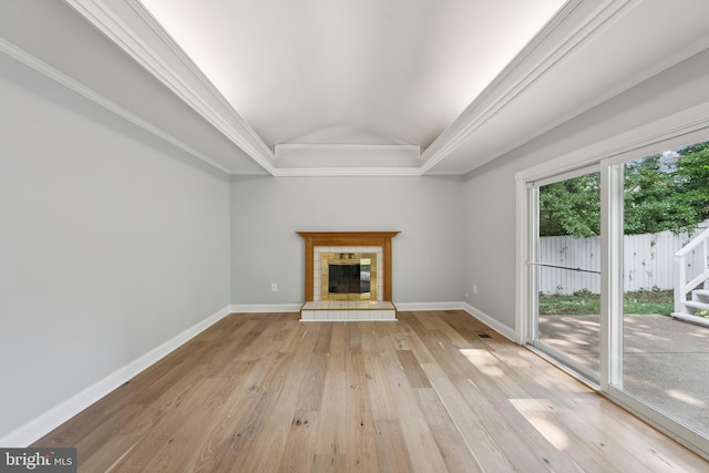 11704 Milbern Dr, Potomac, MD 20854 - unfurnished living room featuring light wood-type flooring, vaulted ceiling, a tile fireplace, and crown molding