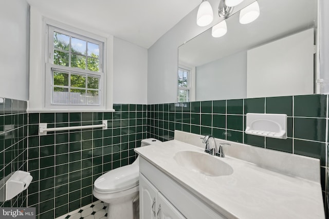 11704 Milbern Dr, Potomac, MD 20854 - half bathroom with vanity, tile walls, and wainscoting