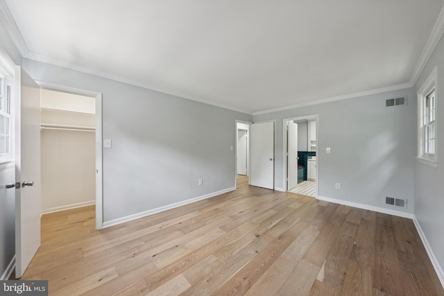 11704 Milbern Dr, Potomac, MD 20854 - unfurnished bedroom featuring a spacious closet, wood finished floors, crown molding, and a closet