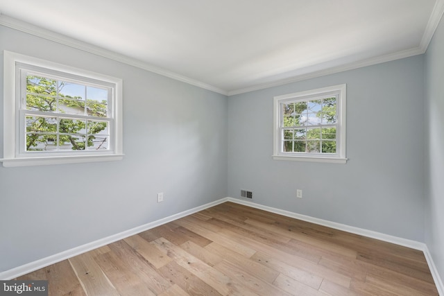 11704 Milbern Dr, Potomac, MD 20854 - spare room featuring plenty of natural light, light wood-style flooring, and ornamental molding