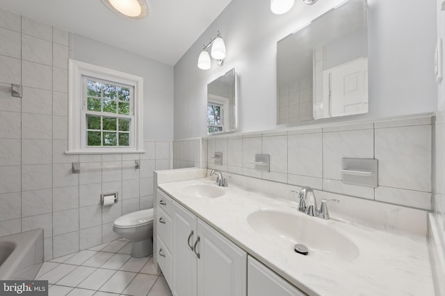 11704 Milbern Dr, Potomac, MD 20854 - bathroom with tile walls, double vanity, tile patterned floors, and a wainscoted wall