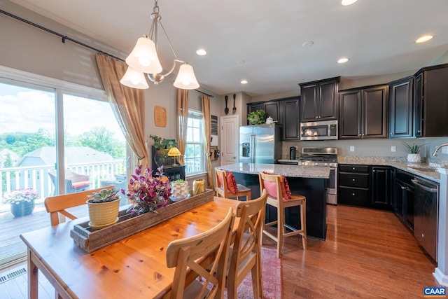 2140 Elm Tree Knl, Charlottesville, VA 22911 - kitchen with stainless steel appliances, a kitchen island, plenty of natural light, light stone countertops, and recessed lighting