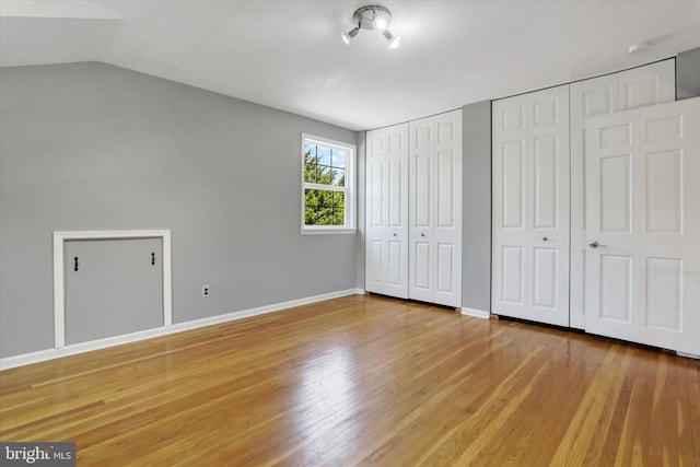 441 Barker Dr, West Chester, PA 19380 - unfurnished bedroom featuring multiple closets, wood finished floors, and vaulted ceiling