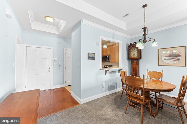 7000 Village Way Unit 408, Boothwyn, PA 19061 - dining space with a raised ceiling and ornamental molding