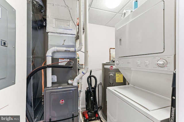 7000 Village Way Unit 408, Boothwyn, PA 19061 - laundry room featuring stacked washing machine and dryer, electric water heater, and heating unit