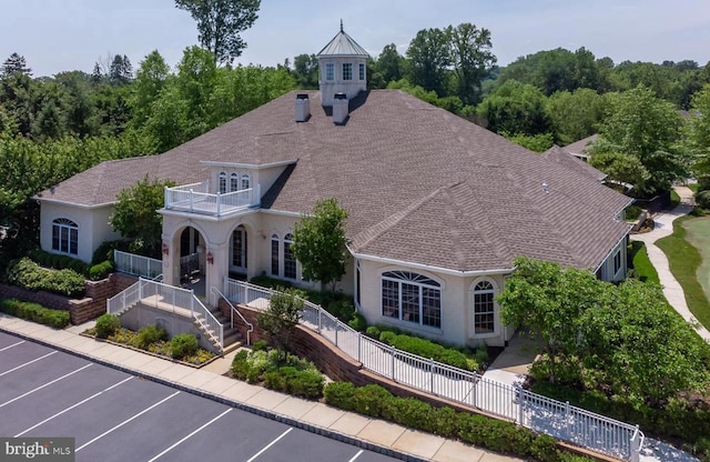 7000 Village Way Unit 408, Boothwyn, PA 19061 - view of front of house featuring a balcony, uncovered parking, and stucco siding