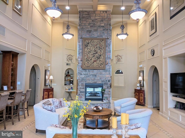 7000 Village Way Unit 408, Boothwyn, PA 19061 - living area featuring arched walkways, a towering ceiling, light tile patterned flooring, inlaid floor details, and ornamental molding