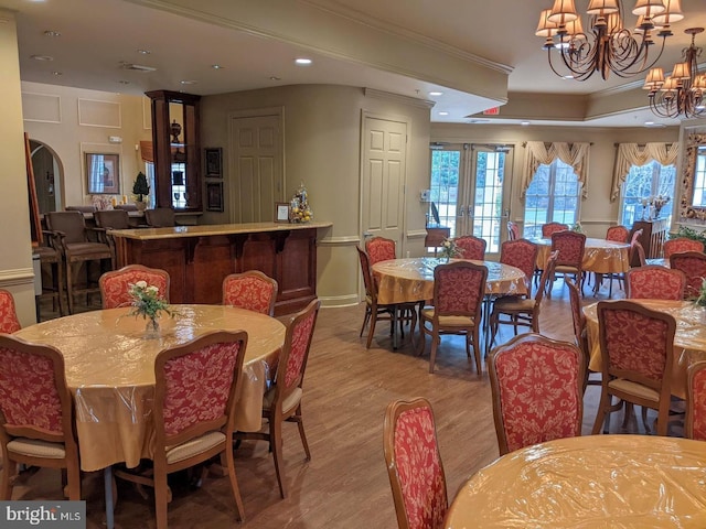 7000 Village Way Unit 408, Boothwyn, PA 19061 - dining space featuring wood finished floors, a chandelier, ornamental molding, recessed lighting, and arched walkways