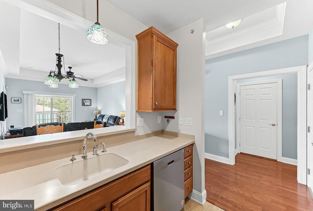 7000 Village Way Unit 408, Boothwyn, PA 19061 - kitchen with stainless steel dishwasher, a tray ceiling, brown cabinets, and crown molding