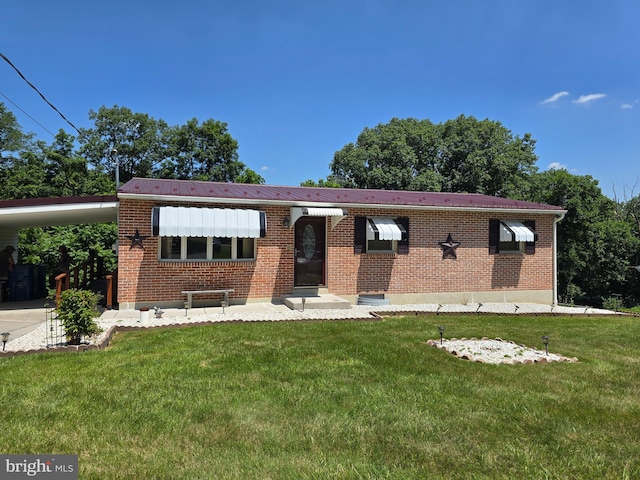 3 Maple Ave, Carlisle, PA 17013 - ranch-style house featuring a front lawn, brick siding, a carport, and a metal roof