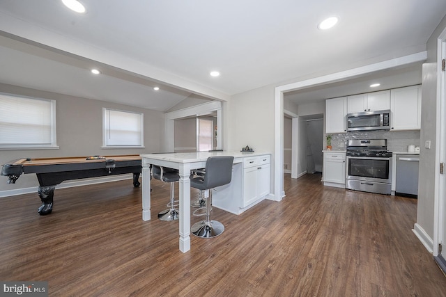 10 Holbrook Rd, Havertown, PA 19083 - kitchen with stainless steel appliances, vaulted ceiling, white cabinets, tasteful backsplash, and light countertops