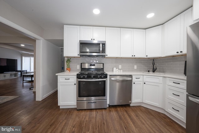 10 Holbrook Rd, Havertown, PA 19083 - kitchen with stainless steel appliances, light countertops, tasteful backsplash, dark wood finished floors, and recessed lighting