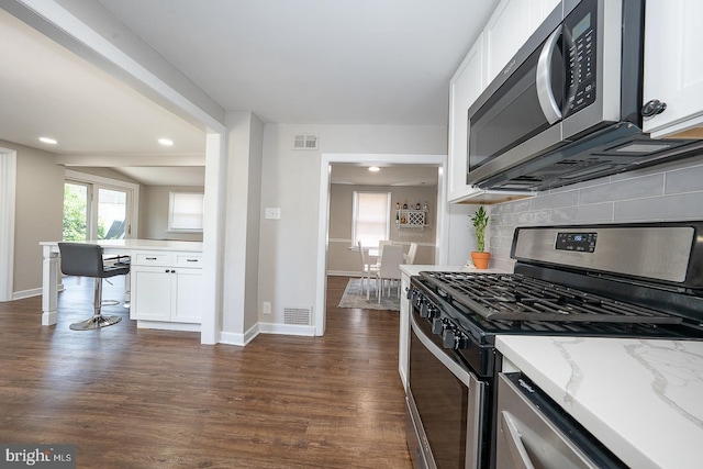 10 Holbrook Rd, Havertown, PA 19083 - kitchen featuring stainless steel appliances, tasteful backsplash, white cabinetry, dark wood-style floors, and recessed lighting