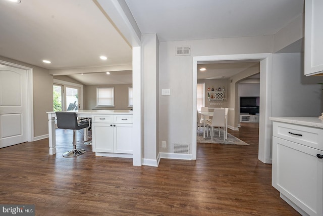 10 Holbrook Rd, Havertown, PA 19083 - kitchen with dark wood-style floors, white cabinetry, light countertops, recessed lighting, and arched walkways