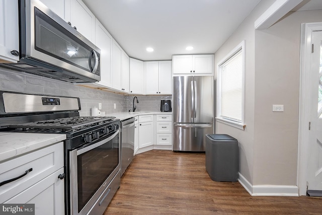 10 Holbrook Rd, Havertown, PA 19083 - kitchen with stainless steel appliances, dark wood-type flooring, tasteful backsplash, white cabinets, and recessed lighting