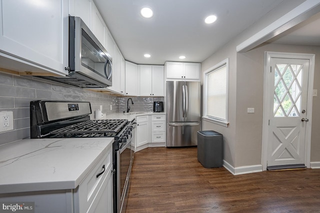 10 Holbrook Rd, Havertown, PA 19083 - kitchen featuring appliances with stainless steel finishes, white cabinets, light stone counters, backsplash, and recessed lighting