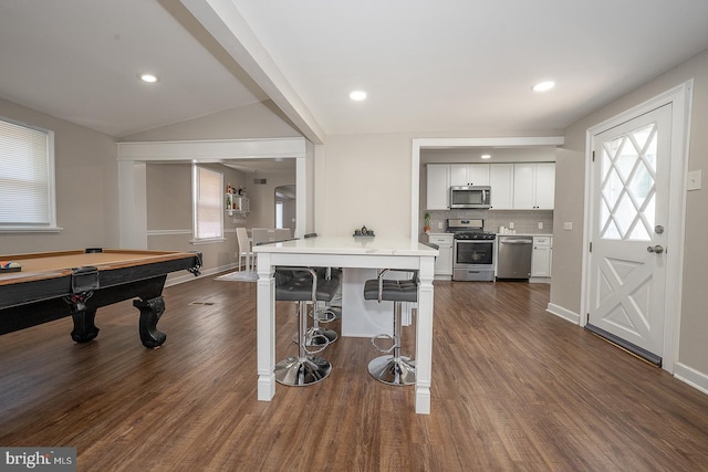 10 Holbrook Rd, Havertown, PA 19083 - kitchen featuring stainless steel appliances, a kitchen breakfast bar, dark wood-type flooring, light countertops, and tasteful backsplash