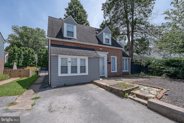 10 Holbrook Rd, Havertown, PA 19083 - view of front facade featuring brick siding, roof with shingles, and a patio