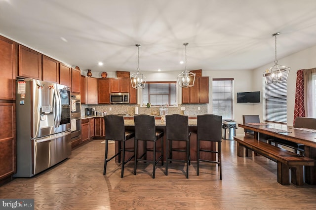 216 Shapley Dr, Smyrna, DE 19977 - kitchen featuring appliances with stainless steel finishes, a chandelier, decorative backsplash, a breakfast bar, and recessed lighting