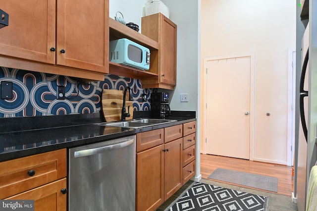 1211 Light St Unit 412, Baltimore, MD 21230 - kitchen featuring stainless steel dishwasher, open shelves, dark countertops, and brown cabinetry