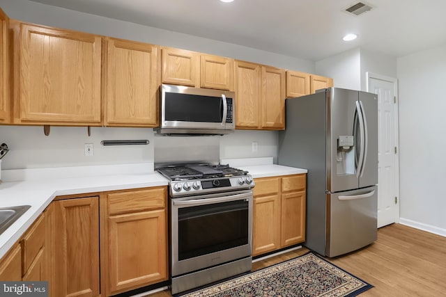 12941 Bridger Dr Unit 1611, Germantown, MD 20874 - kitchen with stainless steel appliances, light wood-style flooring, light countertops, recessed lighting, and light brown cabinetry