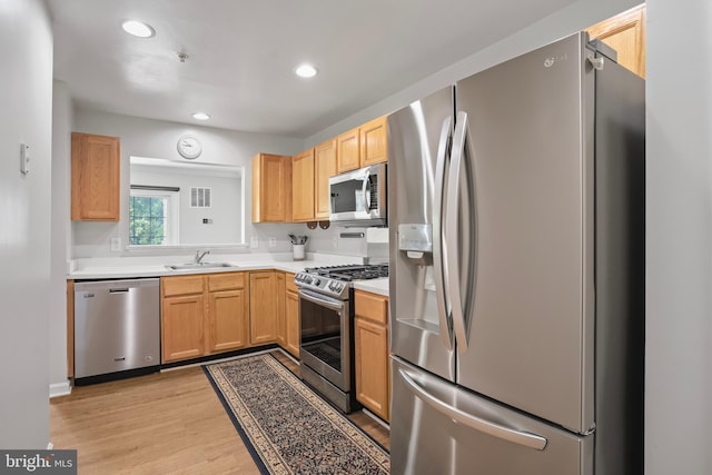 12941 Bridger Dr Unit 1611, Germantown, MD 20874 - kitchen featuring stainless steel appliances, light wood-type flooring, light countertops, recessed lighting, and light brown cabinets