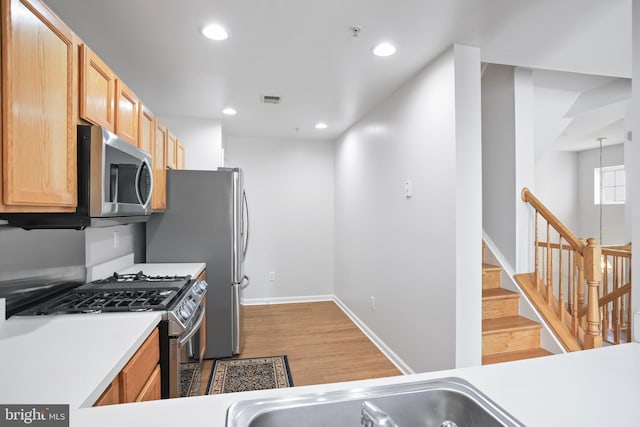 12941 Bridger Dr Unit 1611, Germantown, MD 20874 - kitchen featuring stainless steel appliances, light wood finished floors, light countertops, and recessed lighting