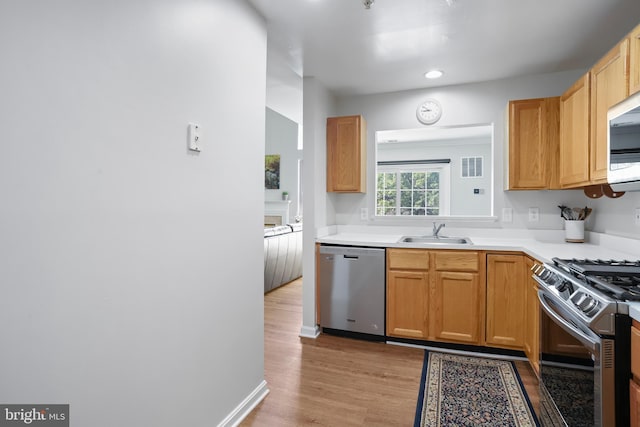 12941 Bridger Dr Unit 1611, Germantown, MD 20874 - kitchen with appliances with stainless steel finishes, light wood-type flooring, light countertops, and recessed lighting