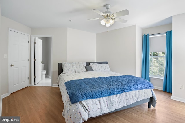 12941 Bridger Dr Unit 1611, Germantown, MD 20874 - bedroom featuring wood finished floors, connected bathroom, and a ceiling fan