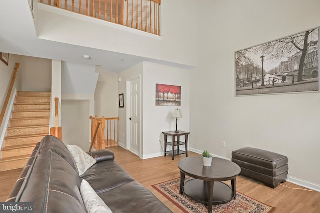 12941 Bridger Dr Unit 1611, Germantown, MD 20874 - living area with wood finished floors, stairway, and a high ceiling