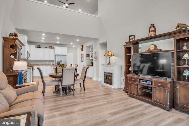 43 Boneset Dr, Gettysburg, PA 17325 - living area with light wood finished floors, a glass covered fireplace, recessed lighting, ceiling fan, and a high ceiling