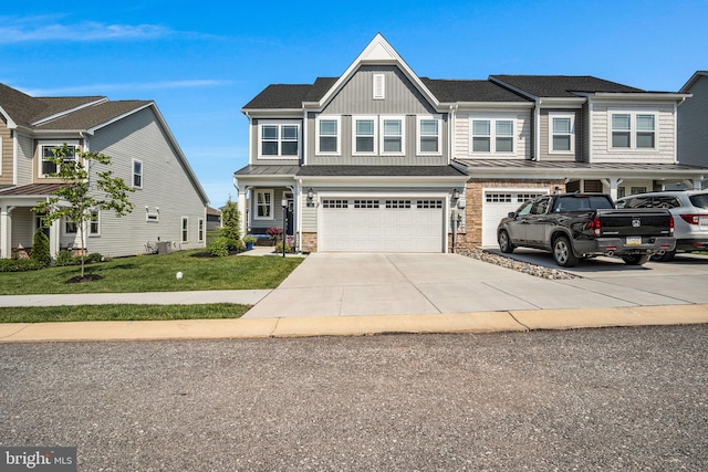 43 Boneset Dr, Gettysburg, PA 17325 - view of front of house featuring board and batten siding, driveway, stone siding, a garage, and a front yard