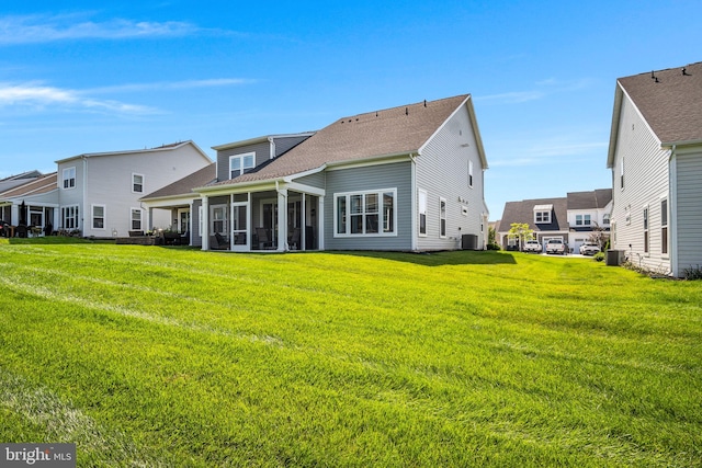 43 Boneset Dr, Gettysburg, PA 17325 - rear view of property with a sunroom, roof with shingles, and a lawn