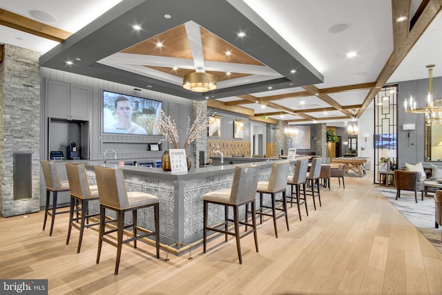 43 Boneset Dr, Gettysburg, PA 17325 - kitchen with coffered ceiling, beamed ceiling, light wood-style flooring, a large island, and a breakfast bar area