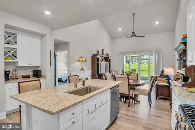 43 Boneset Dr, Gettysburg, PA 17325 - kitchen featuring stainless steel appliances, open floor plan, white cabinets, light wood-style floors, and high vaulted ceiling