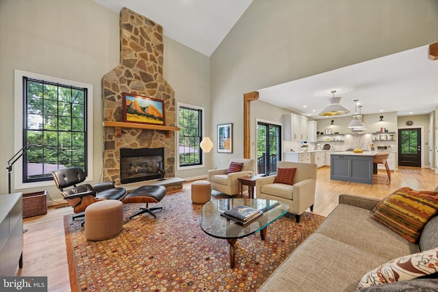 150 Waterview Dr, Glenmoore, PA 19343 - living area with high vaulted ceiling, light wood-style flooring, plenty of natural light, and a fireplace