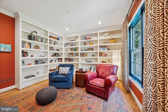 150 Waterview Dr, Glenmoore, PA 19343 - sitting room featuring wood finished floors, crown molding, built in shelves, and recessed lighting