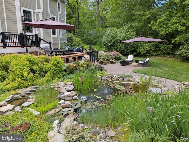 150 Waterview Dr, Glenmoore, PA 19343 - view of yard with a deck, a patio, a small pond, and a fire pit