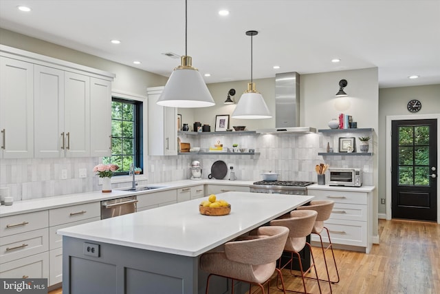 150 Waterview Dr, Glenmoore, PA 19343 - kitchen featuring range hood, open shelves, appliances with stainless steel finishes, light countertops, and a center island
