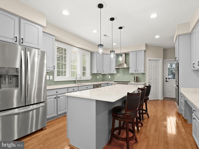 6720 Walter Scott Way, Columbia, MD 21044 - kitchen with stainless steel appliances, wall chimney exhaust hood, gray cabinets, a center island, and tasteful backsplash