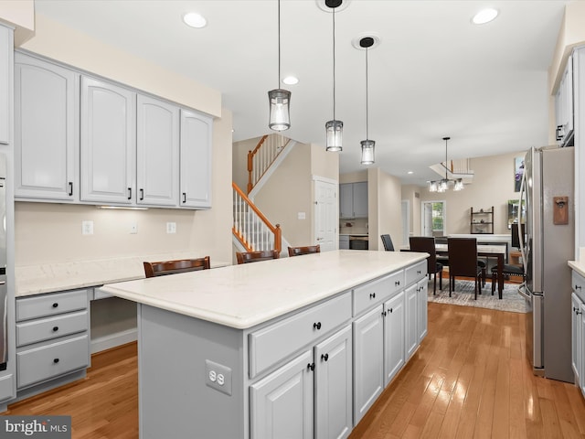 6720 Walter Scott Way, Columbia, MD 21044 - kitchen with freestanding refrigerator, a center island, light wood-style flooring, recessed lighting, and white cabinets