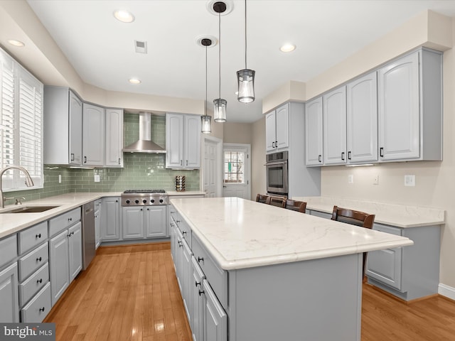 6720 Walter Scott Way, Columbia, MD 21044 - kitchen featuring gray cabinetry, appliances with stainless steel finishes, wall chimney range hood, light wood-type flooring, and recessed lighting