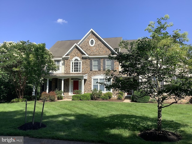 6720 Walter Scott Way, Columbia, MD 21044 - colonial house with stone siding, a front yard, covered porch, and a standing seam roof