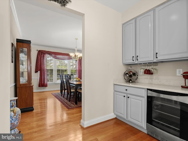 6720 Walter Scott Way, Columbia, MD 21044 - indoor dry bar featuring beverage cooler, a chandelier, light wood-type flooring, and crown molding