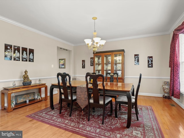 6720 Walter Scott Way, Columbia, MD 21044 - dining area with a chandelier, wood finished floors, and crown molding