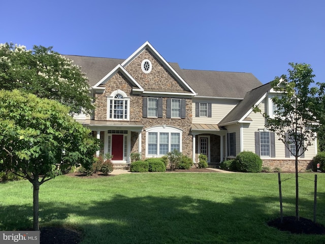 6720 Walter Scott Way, Columbia, MD 21044 - view of front facade featuring stone siding, a front lawn, a standing seam roof, and a metal roof