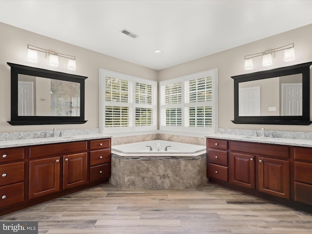 6720 Walter Scott Way, Columbia, MD 21044 - full bathroom with two vanities, a bath, wood finished floors, and recessed lighting