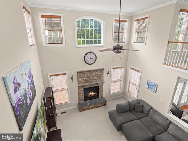 6720 Walter Scott Way, Columbia, MD 21044 - carpeted living area featuring ceiling fan, a towering ceiling, crown molding, a stone fireplace, and plenty of natural light