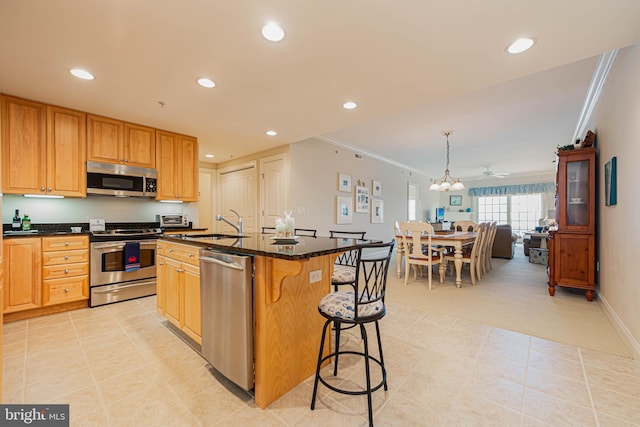 301 14th St Unit 304, Ocean City, MD 21842 - kitchen featuring appliances with stainless steel finishes, a kitchen breakfast bar, light colored carpet, ornamental molding, and recessed lighting